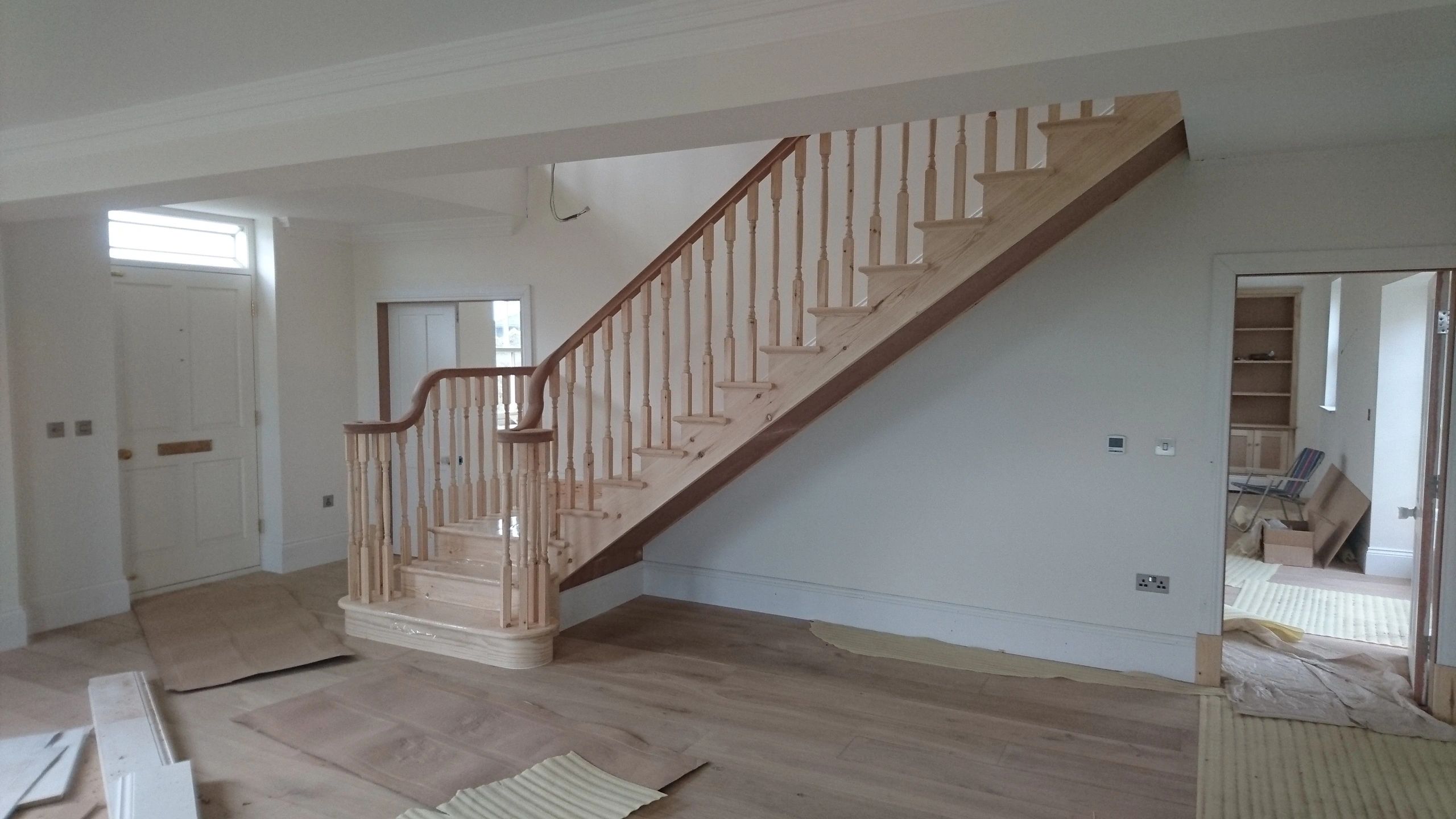 Classic closed string timber staircase installation meeting UK building regulations