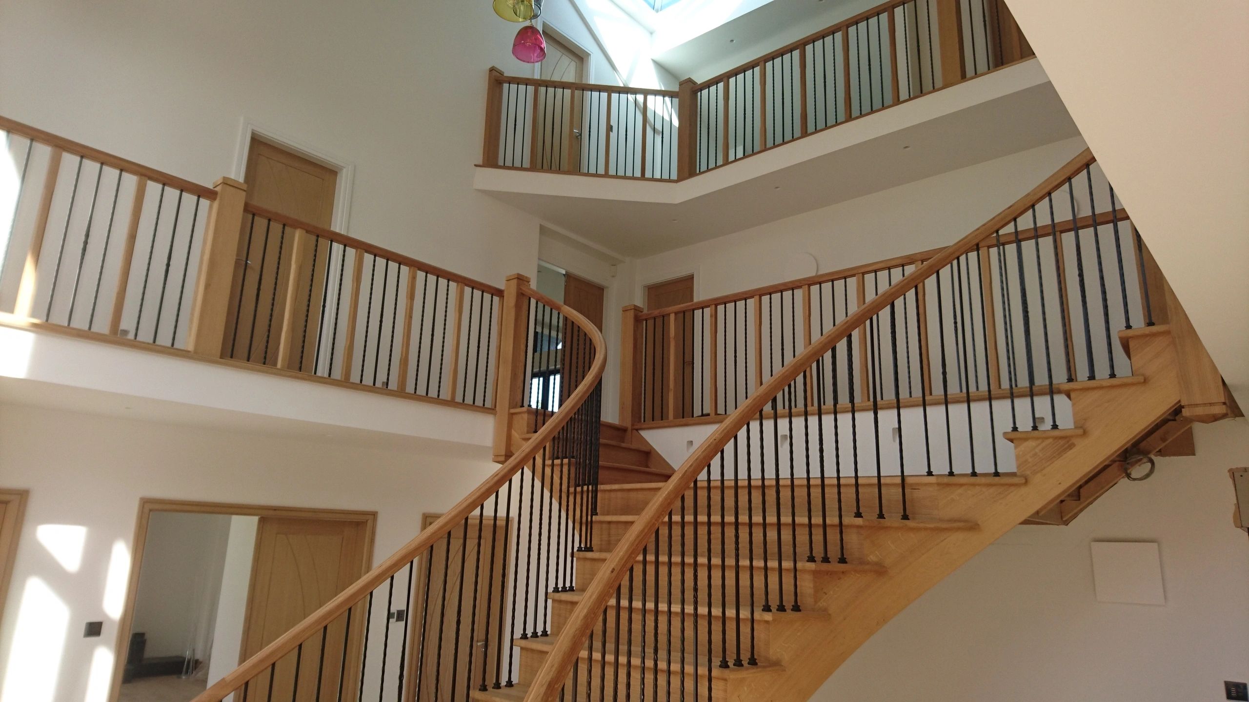 Detailed view of bespoke balustrade with traditional turned spindles on finished timber staircase